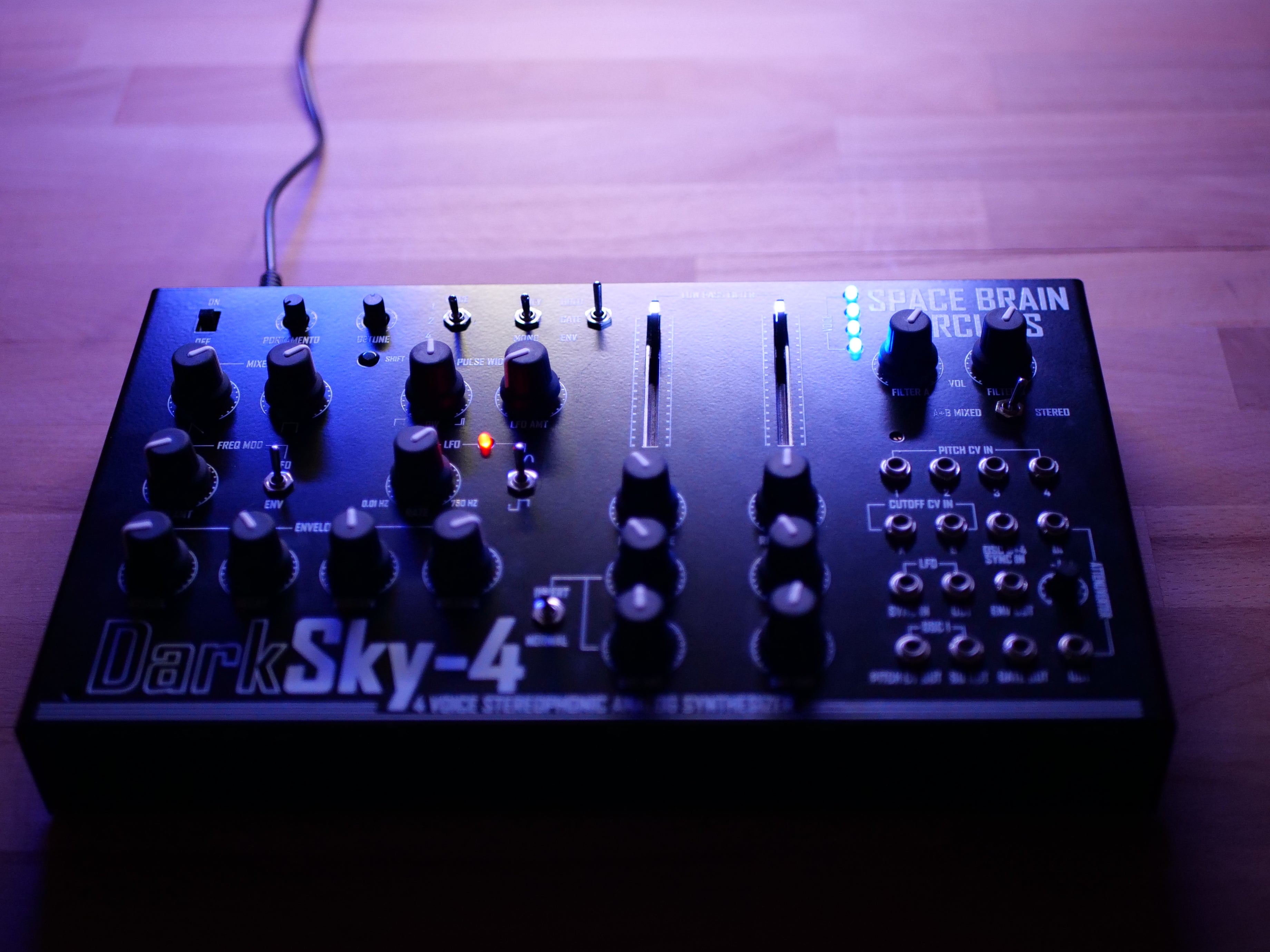 Photograph of DarkSky-4 in low purple light. Front facing image.