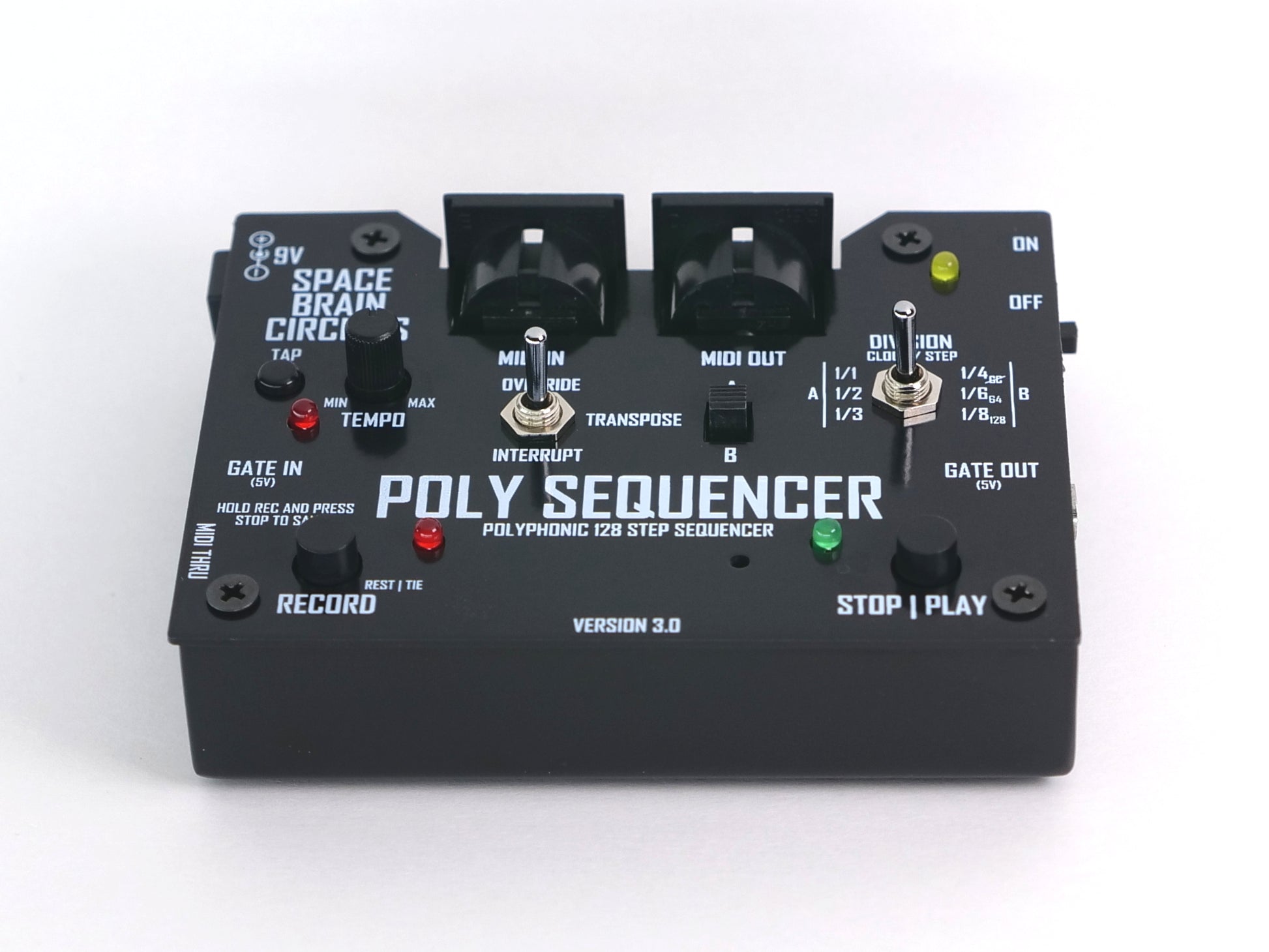 A black Poly Sequencer 128 step sequencer pedal by Space Brain Circuits, featuring a rotary knob, switches, and illuminated red and green indicator lights on a white background.