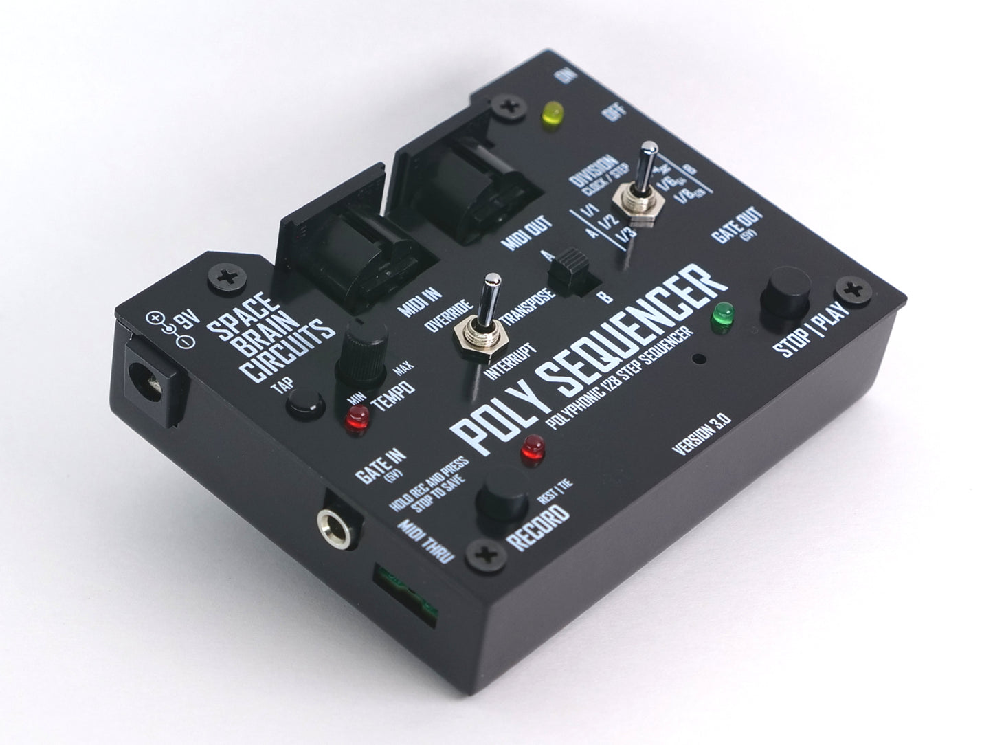 A black Poly Sequencer electronic music device with various knobs, switches, and illuminated red and green LED indicators, photographed on a clean white background.