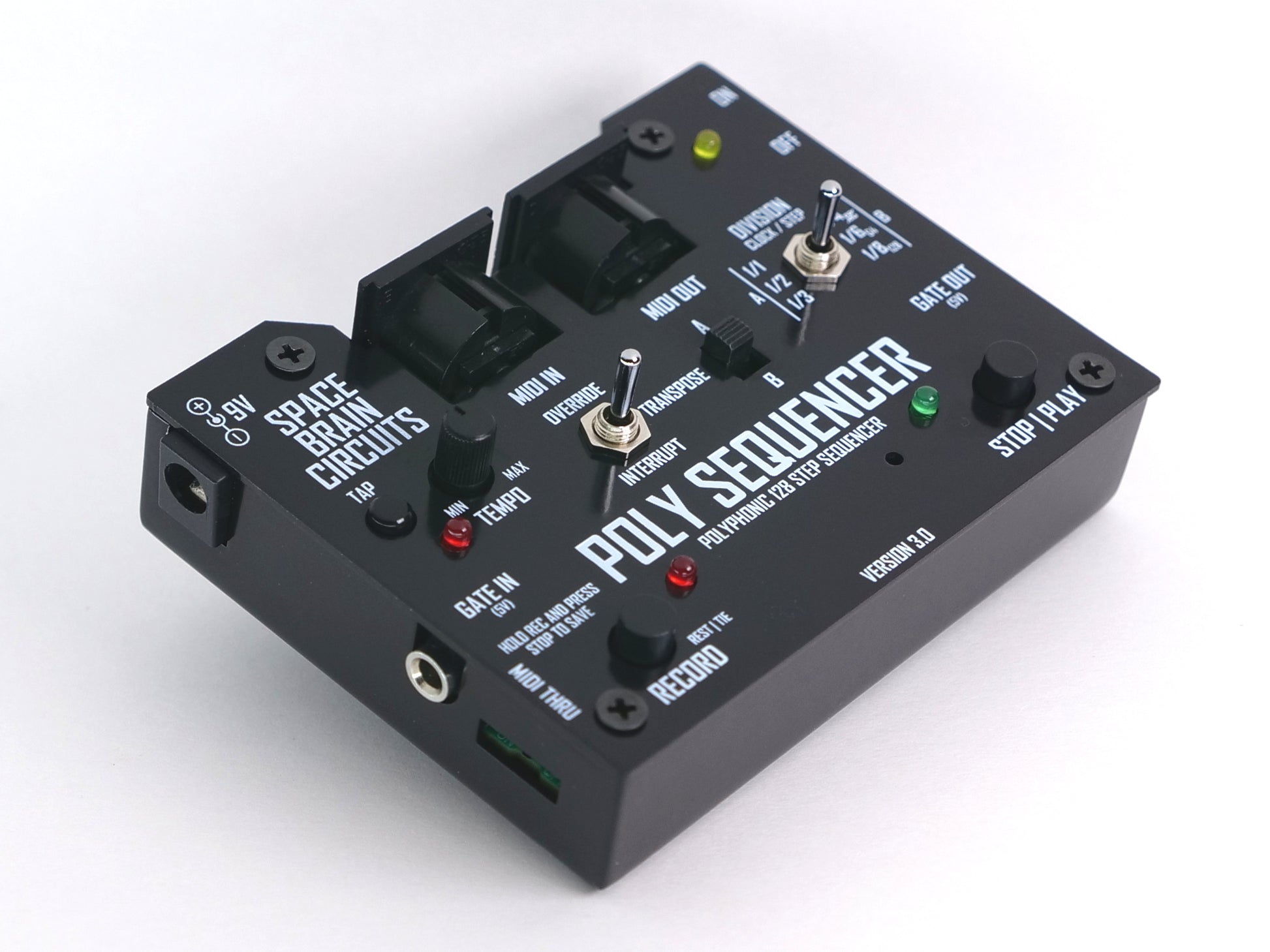 A black Poly Sequencer electronic music device with various knobs, switches, and illuminated red and green LED indicators, photographed on a clean white background.